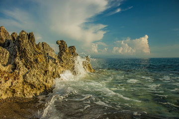 Aegean sea landscape rocky beach shoreline and waves breaks on stone