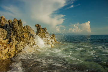 Aegean sea landscape rocky beach shoreline and waves breaks on stone