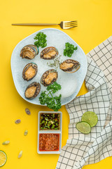 Chilled abalone sashimi in a white dish
