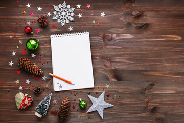 Christmas and New Year background with notepad, pencil and decorations. To do list or list of promises, place for your text. Mock up.