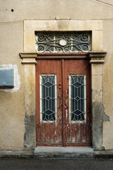 Fototapeta na wymiar Brown wooden vintage door on sandstone wall background
