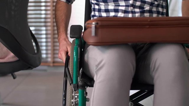 Man's in a wheelchair at work