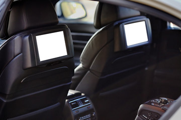 Car inside headrest screen mock up. Two white displays for back seats passenger with media control...