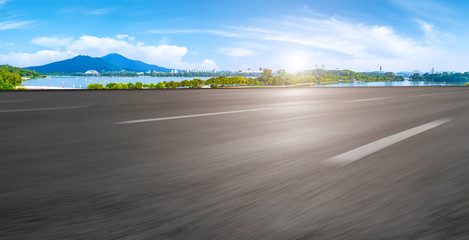 Fototapeta premium Empty asphalt road square and natural landscape under the blue sky