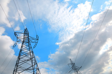 Overhead transmission of electricity through high voltage lines with ropes between high columns.