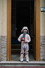 Little boy dressed in mummy in the street
