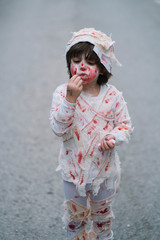 Little boy dressed in mummy in the street