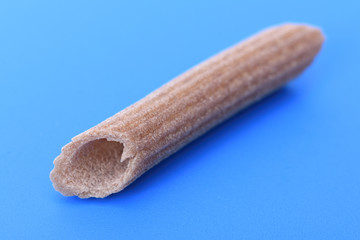 Pasta buckwheat macaroni on blue background