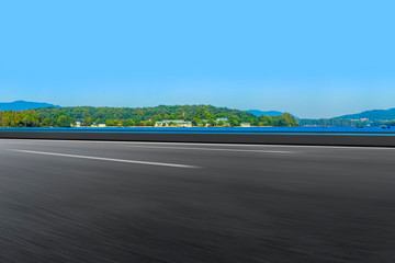 Empty asphalt road and natural landscape under the blue sky