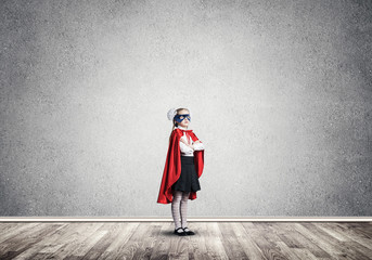 Girl power concept with cute kid guardian in empty room. Mixed m