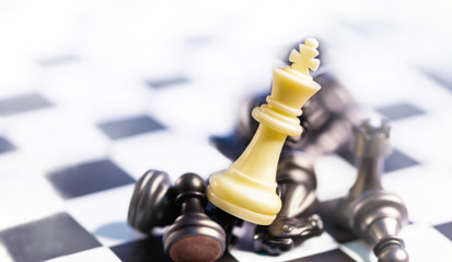 business winner concept, the white king chess stand on top of the black cheses on game board