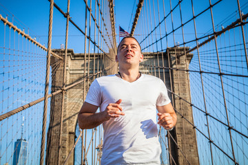 Young athlete jogging on Brooklyn Bridge in New York City