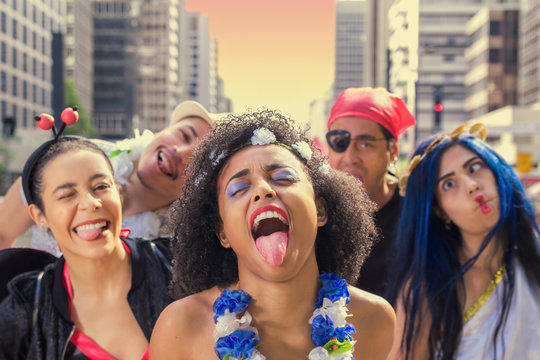 Group of young women in costumes celebrating Brazil Carnaval at the disco.  Portrait of revelers dressed as Pirate, Hawaiian and Hippie at Brazilian  Carnival. Stock Photo