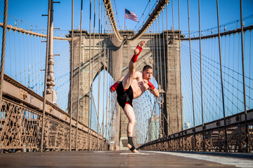 Young athlete fighter exercising on Brooklyn bridge in New York City