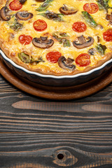Baked homemade quiche pie in ceramic baking form