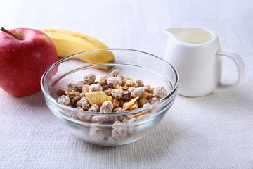 Healthy food with Corn Flakes cereal in a bowl, apple, banana and glass with milk. Morning breakfast.