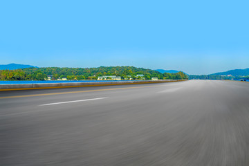 Empty asphalt road and natural landscape under the blue sky