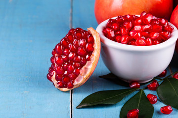 Ripe pomegranate fruits on the wooden background