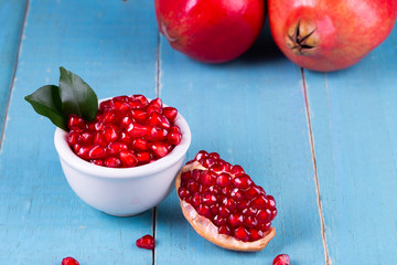 Ripe pomegranate fruits on the wooden background