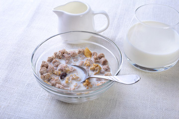 Healthy food with Corn Flakes cereal in a bowl, apple, banana and glass with milk. Morning breakfast.