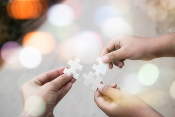Teamwork holding connecting  piece jigsaw puzzle