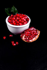 Ripe pomegranate fruits on the wooden background