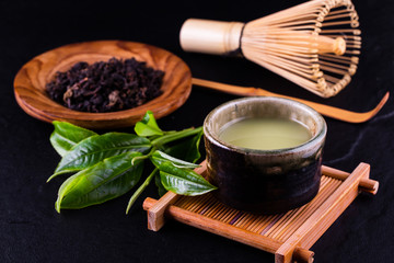 Top view of green tea matcha in a bowl on wooden surface