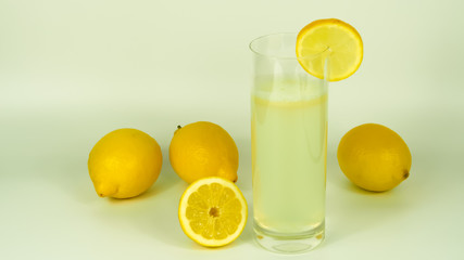 complete and sliced lemons next to a drink