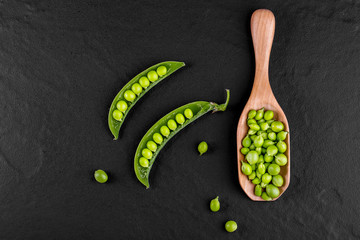 Sugar snap peas with mint on a rustic wood background