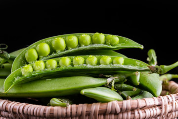 Sugar snap peas with mint on a rustic wood background