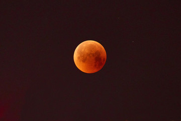 Red moon, total lunar eclipse. A total moon eclipse in the dark night sky.