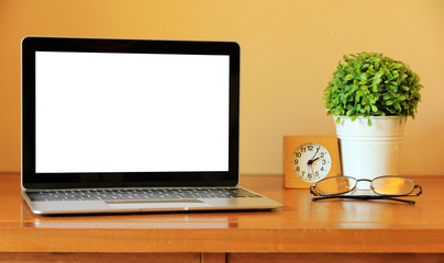 blank screen Modern laptop computer with cactus on wood table in office view backgrounds