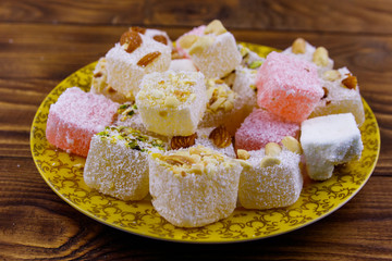 Turkish delight in a plate on wooden table