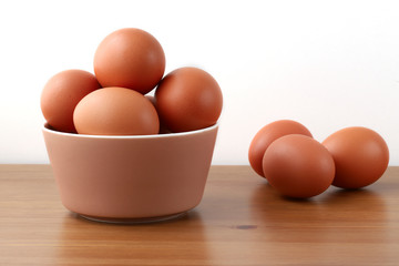 Chicken eggs in a bowl on the table
