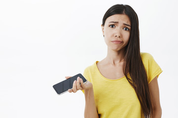 Waist-up shot of displeased moody and unimpressed attractive stylish woman being fed up with old...