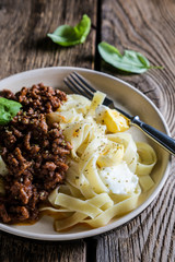 bolognese pasta on wooden table