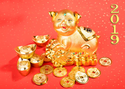 2019 is year of the pig,Golden piggy bank,calligraphy on pig translation: good bless for saving and wealth. Chinese Language on ignot and gold coin mean "Wealthy".