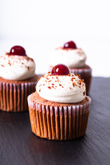 Confection Dessert Homemade Black forest cupcake on a black slate stone plate with copy space