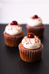 Confection Dessert Homemade Black forest cupcake on a black slate stone plate with copy space