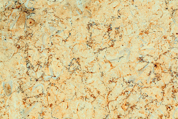 Polished yellow marble with orange and gray streaks, texture