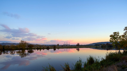 Panoramic View Of A Lake At Sunset With A Coal Power Station In