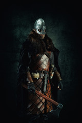 Naklejka premium Portrait of a Viking holding an ax in his hand