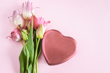 Valentine card: Beautiful pink heart and bouquet of pink and pink tulips on pink background with copy space