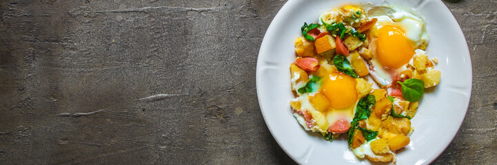 Fried eggs with spinach, sausage and breadcrumbs - healthy breakfast (quick meal). Top view. copy space