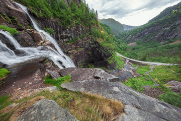 Fototapeta na wymiar The base of the Skjervsfossen with the valley and the road next to it.