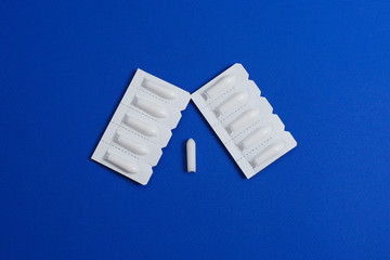 Medical Suppository, Rectal or Vaginal. Isolated on blue Background.