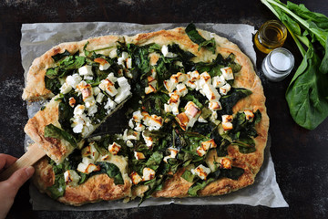 Healthy homemade pizza with spinach and feta.