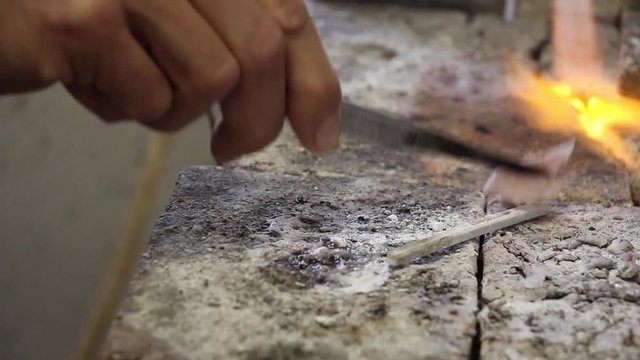 human carefully calefaction and wetting of silver blanks with flux (composition against oxidation), workshop jewelry