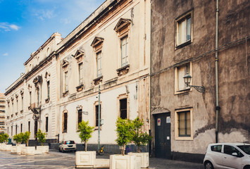 Fototapeta na wymiar Travel to Italy - historical street of Catania, Sicily, facade of old buildings.