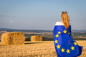 Woman holding european union flag in nature